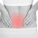 Close up of woman having back pain isolated on white background